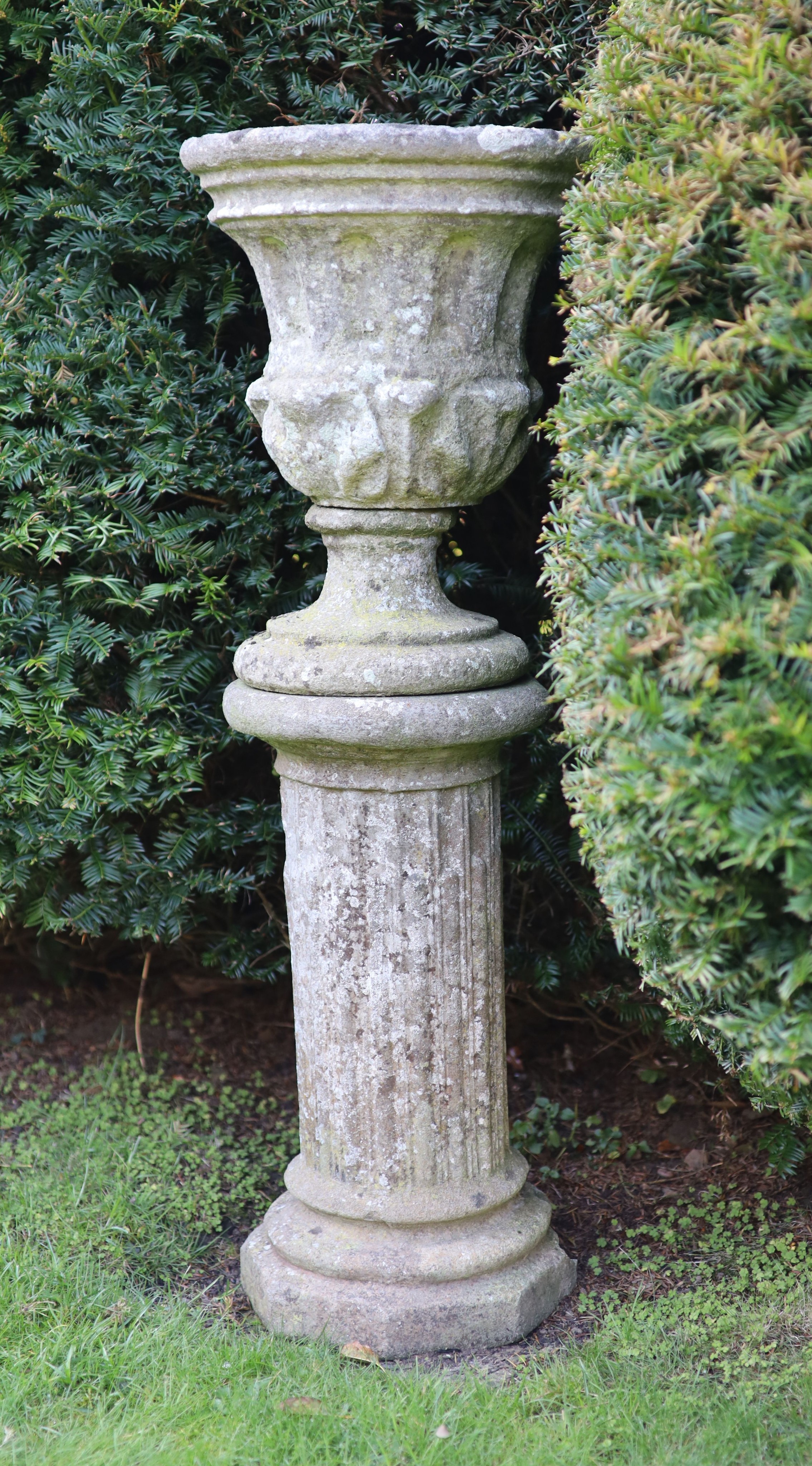 A reconstituted stone garden urn on fluted pedestal, height 112cm diameter 40cm